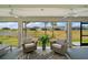 Relaxing lanai featuring comfortable seating and scenic views of the lake and community at 7669 Chastain Cir, Middleton, FL 34762