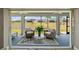 Inviting screened lanai with ceiling fans and views of the serene lake and lush landscaping at 7669 Chastain Cir, Middleton, FL 34762