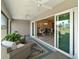 Relaxing lanai with indoor-outdoor living, ceiling fans, and a view of the outdoor dining area at 7669 Chastain Cir, Middleton, FL 34762
