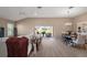 Open-concept living room and dining area with sliding glass doors leading to the patio and backyard at 7669 Chastain Cir, Middleton, FL 34762