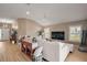 Spacious living room with abundant natural light, wood-look floors, and comfortable seating arrangements at 7669 Chastain Cir, Middleton, FL 34762