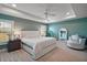 Relaxing main bedroom with tray ceiling, fan, sitting area and natural light at 7669 Chastain Cir, Middleton, FL 34762
