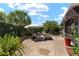 Inviting backyard patio featuring a lush garden, patio furniture, and a fire pit for outdoor enjoyment at 850 Oviedo Rd, Lady Lake, FL 32159