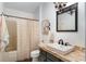 Cozy bathroom with a single sink vanity and a framed mirror adds to the aesthetic appeal at 850 Oviedo Rd, Lady Lake, FL 32159