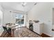 Bright breakfast nook with pool views and a small refrigerator at 850 Oviedo Rd, Lady Lake, FL 32159