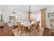 Spacious dining area featuring modern decor, hardwood floors, and seamless transition to the living room at 850 Oviedo Rd, Lady Lake, FL 32159