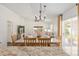 Bright, open-concept space with dining area, chandelier, and a seamless transition to the living room at 850 Oviedo Rd, Lady Lake, FL 32159