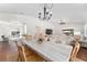 Bright dining area featuring a marble table, chandelier, and views of the pool and living room at 850 Oviedo Rd, Lady Lake, FL 32159