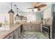 Charming kitchen featuring granite countertops, modern appliances, and custom tile flooring at 850 Oviedo Rd, Lady Lake, FL 32159