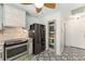 Well-appointed kitchen featuring modern appliances, custom tile flooring, and a stylish leaf-blade ceiling fan at 850 Oviedo Rd, Lady Lake, FL 32159