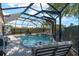 Backyard pool with screened enclosure, patio furniture, and beautifully landscaped surroundings for relaxation and enjoyment at 850 Oviedo Rd, Lady Lake, FL 32159