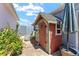 Charming backyard shed with a stone and cedar exterior nestled in a neatly landscaped garden at 850 Oviedo Rd, Lady Lake, FL 32159