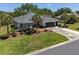 Aerial view of a lovely single-story home with a well-maintained lawn and landscaping at 8715 Se 176Th Lowndes Pl, The Villages, FL 32162