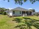Lush backyard featuring a well-maintained lawn and a screened-in patio at 8715 Se 176Th Lowndes Pl, The Villages, FL 32162