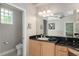 Well-lit bathroom with wood cabinets, granite countertops, and neutral wall color at 8715 Se 176Th Lowndes Pl, The Villages, FL 32162