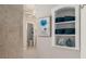 Bathroom with a shelf that has towels and a glimpse of the commode in the background at 8715 Se 176Th Lowndes Pl, The Villages, FL 32162