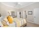 This bedroom offers a neutral color scheme, a ceiling fan, and multiple entry points at 8715 Se 176Th Lowndes Pl, The Villages, FL 32162
