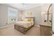 Cozy bedroom with natural light, a ceiling fan, and a comfortable bed with yellow accents at 8715 Se 176Th Lowndes Pl, The Villages, FL 32162