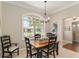 Dining room features bright natural light from the large window overlooking the front yard at 8715 Se 176Th Lowndes Pl, The Villages, FL 32162