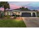 Charming single-story home featuring a well-manicured lawn and a two-car garage at 8715 Se 176Th Lowndes Pl, The Villages, FL 32162