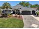 Beautiful single-story home with a well-kept lawn and a spacious driveway at 8715 Se 176Th Lowndes Pl, The Villages, FL 32162