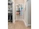 Hallway leading to the main bathroom and closet, blending functionality with stylish design at 8715 Se 176Th Lowndes Pl, The Villages, FL 32162