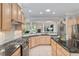 Kitchen with center island and black marble countertops opens to the living area at 8715 Se 176Th Lowndes Pl, The Villages, FL 32162