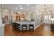 Open kitchen with black granite countertops, stainless steel appliances and bar seating at 8715 Se 176Th Lowndes Pl, The Villages, FL 32162