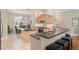 Modern kitchen with black granite countertops, eat in island and stainless steel range at 8715 Se 176Th Lowndes Pl, The Villages, FL 32162