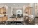 Open kitchen area with eat in kitchen table, black granite countertops, and gas range at 8715 Se 176Th Lowndes Pl, The Villages, FL 32162