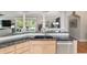 Bright kitchen with black marble counters, stainless appliances, and open to the living room at 8715 Se 176Th Lowndes Pl, The Villages, FL 32162