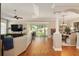 Spacious living room with wood floors, slider doors to the lanai, and an open dining area at 8715 Se 176Th Lowndes Pl, The Villages, FL 32162