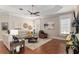 Inviting living room with hardwood floors, plenty of seating, and natural light at 8715 Se 176Th Lowndes Pl, The Villages, FL 32162