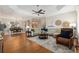 Open-concept living room boasts hardwood floors, coffered ceilings, and neutral decor with seamless flow to dining and kitchen at 8715 Se 176Th Lowndes Pl, The Villages, FL 32162