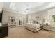 Cozy bedroom with plush carpet, neutral tones, French doors, and ample natural light at 8715 Se 176Th Lowndes Pl, The Villages, FL 32162