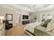 Serene main bedroom with comfortable furnishings, tray ceiling, TV, and ensuite bathroom at 8715 Se 176Th Lowndes Pl, The Villages, FL 32162
