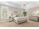A well-lit bedroom showcases a comfortable bed, soft lighting, and a serene ambiance at 8715 Se 176Th Lowndes Pl, The Villages, FL 32162