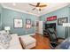 Office space with a sofa, decor, wood flooring, and natural light coming in from a window at 8715 Se 176Th Lowndes Pl, The Villages, FL 32162
