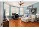 Home office with built-in shelves, hardwood floors and a bay window providing natural light at 8715 Se 176Th Lowndes Pl, The Villages, FL 32162