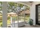 Screened patio with view of fenced backyard and mature trees at 8715 Se 176Th Lowndes Pl, The Villages, FL 32162