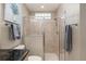 Neutral-tiled shower features glass enclosure and towel racks, creating a spa-like experience at 8715 Se 176Th Lowndes Pl, The Villages, FL 32162