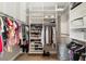 Spacious walk-in closet with ample shelving and rods for organized storage at 8715 Se 176Th Lowndes Pl, The Villages, FL 32162