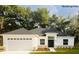 Charming single-story home featuring an attached two-car garage and a well-manicured front yard at 8742 Se 158Th Pl, Summerfield, FL 34491