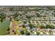 Expansive aerial view showcasing the neighborhood's well-maintained homes and community pond at 929 Eastmont Ct, The Villages, FL 32162