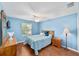 Comfortable bedroom with a ceiling fan, wood-look floors, natural light, and bedside tables at 929 Eastmont Ct, The Villages, FL 32162
