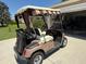Golf cart located near a community garage is ideal for transportation around the neighborhood at 929 Eastmont Ct, The Villages, FL 32162
