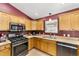 The kitchen offers stainless steel appliances, ample counter space, wooden cabinets and modern finishes at 929 Eastmont Ct, The Villages, FL 32162