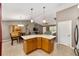 Open kitchen area with an island, tile flooring, dining area, and an adjacent living room at 929 Eastmont Ct, The Villages, FL 32162