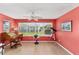 Bright living room featuring large window, desk, and telescope for enjoying outdoor views at 929 Eastmont Ct, The Villages, FL 32162