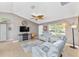 Comfortable living area with tile floors, ceiling fan, and bright windows offering plenty of natural light at 929 Eastmont Ct, The Villages, FL 32162